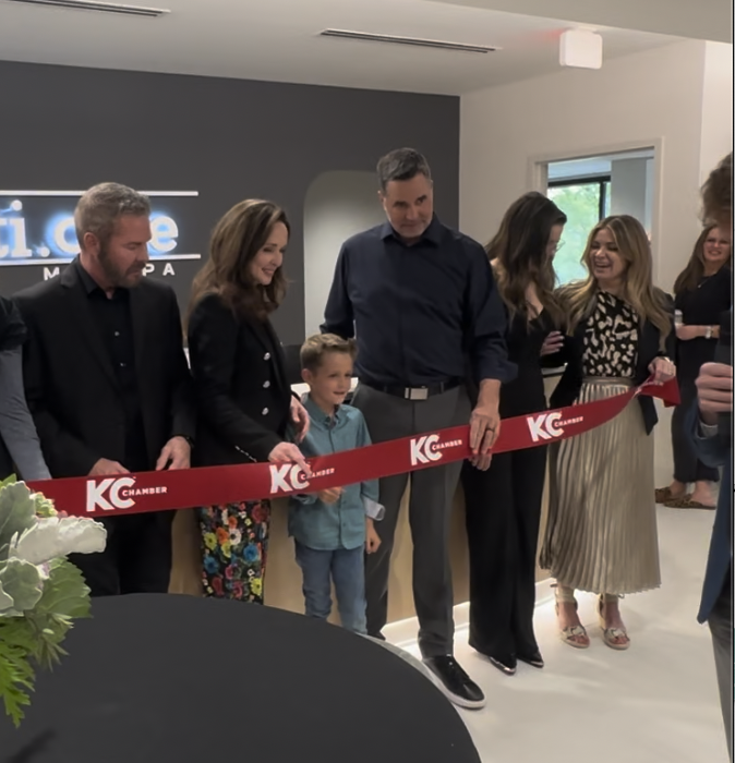 Team cutting the ribbon at their new medspa, AesthetiCare