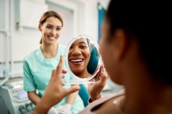 Close,Up,Of,African,American,Woman,Using,Mirror,While,Looking